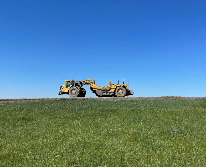 Earth moving equipment on hill