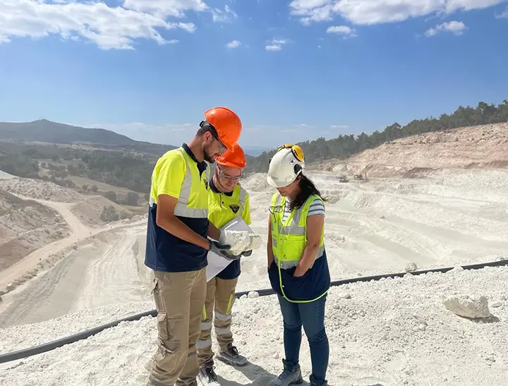 Three workers out in the field